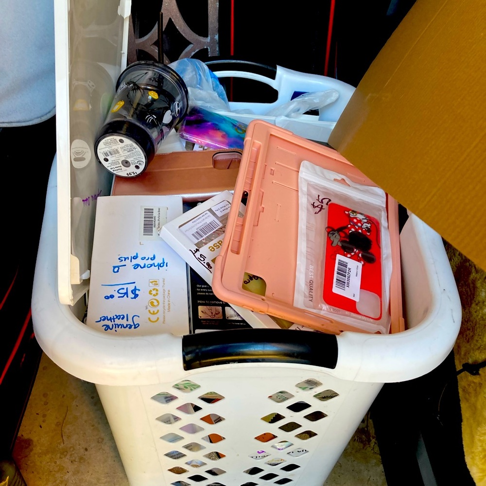 A whole laundry basket full of various types of phone and tablet cases